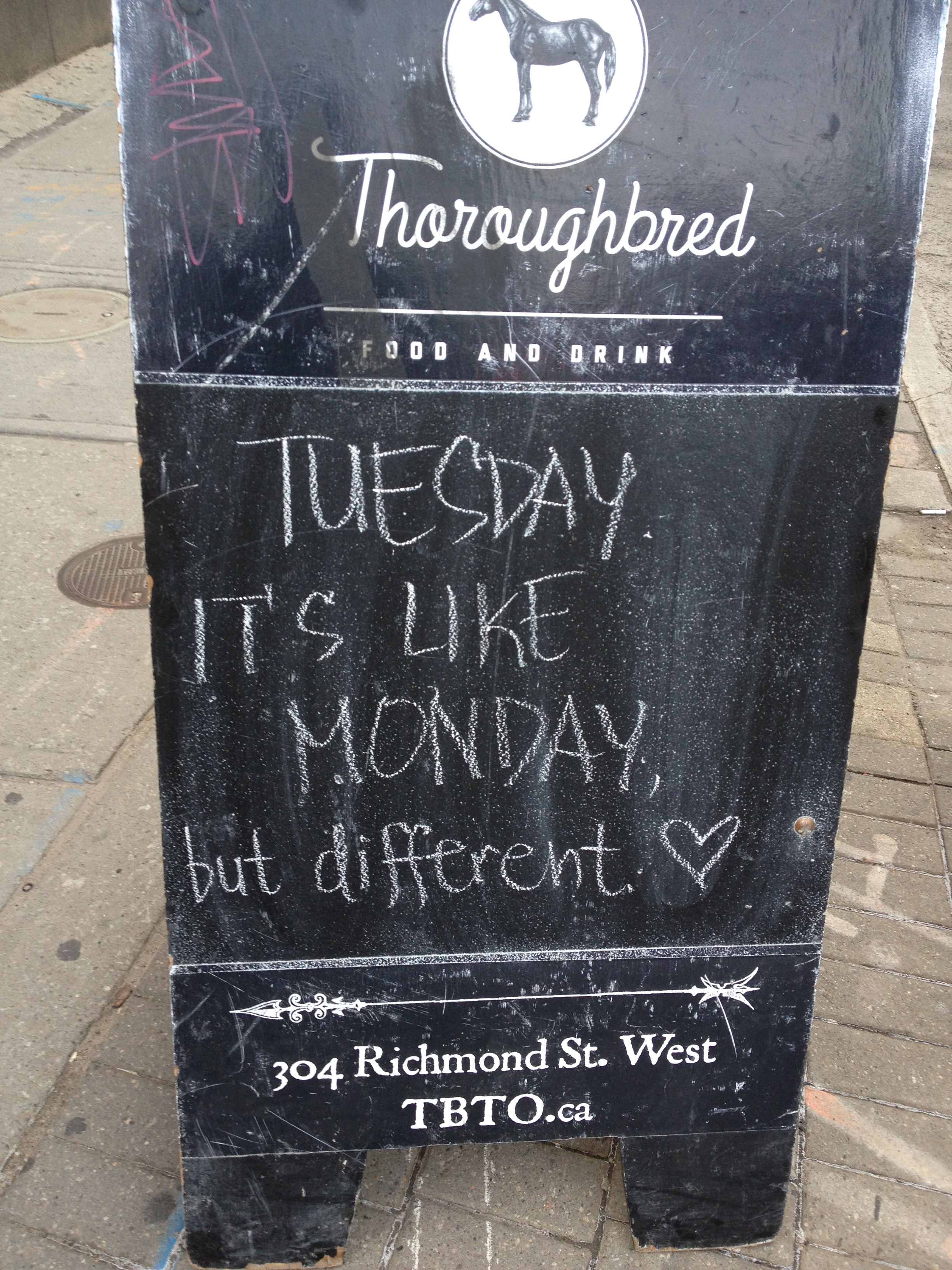 Pub roadside sign saying “Tuesday. It's like Monday, but different. ♡”